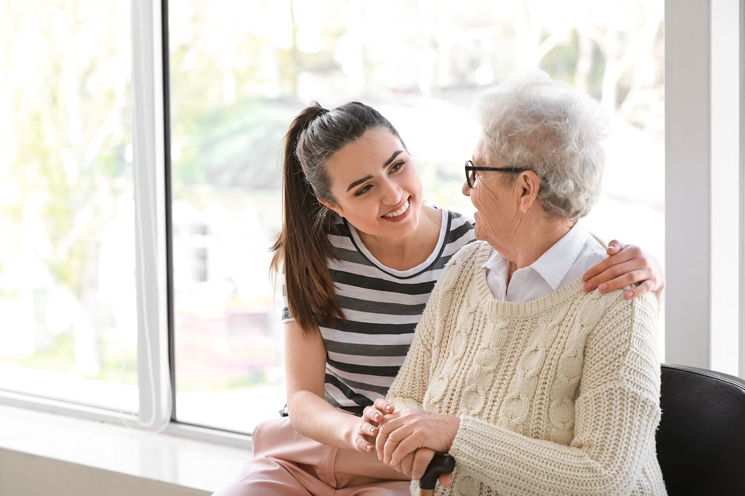 Granddaughter visiting her grandmother in a personal care home.