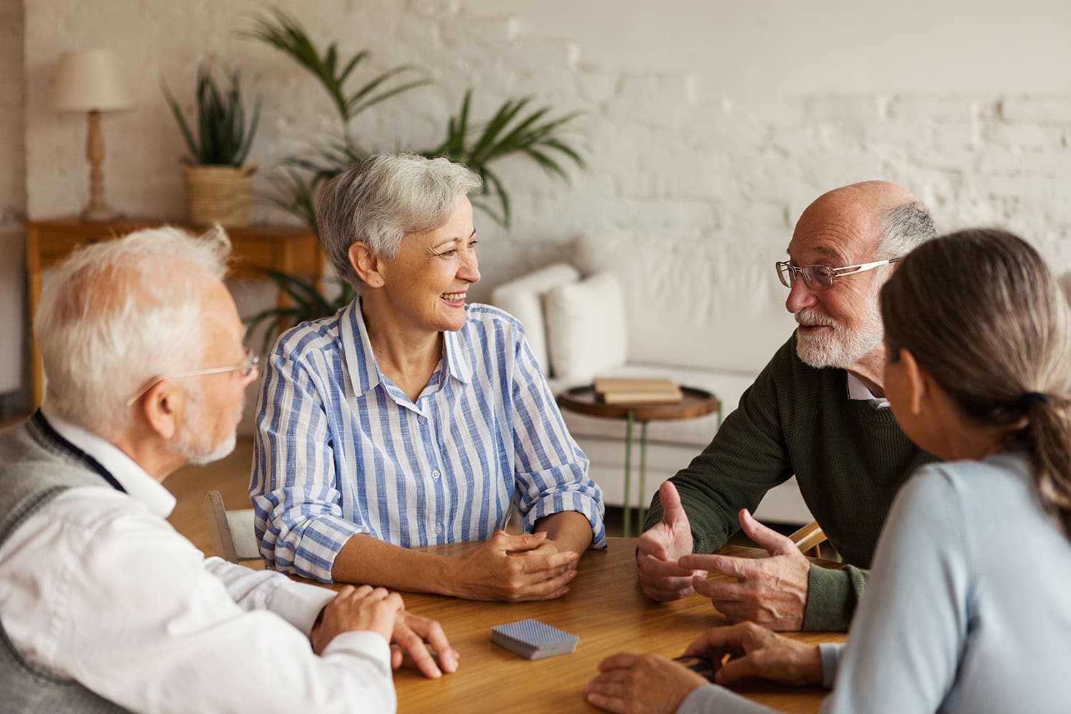 Seniors enjoying conversation together at a personal care community